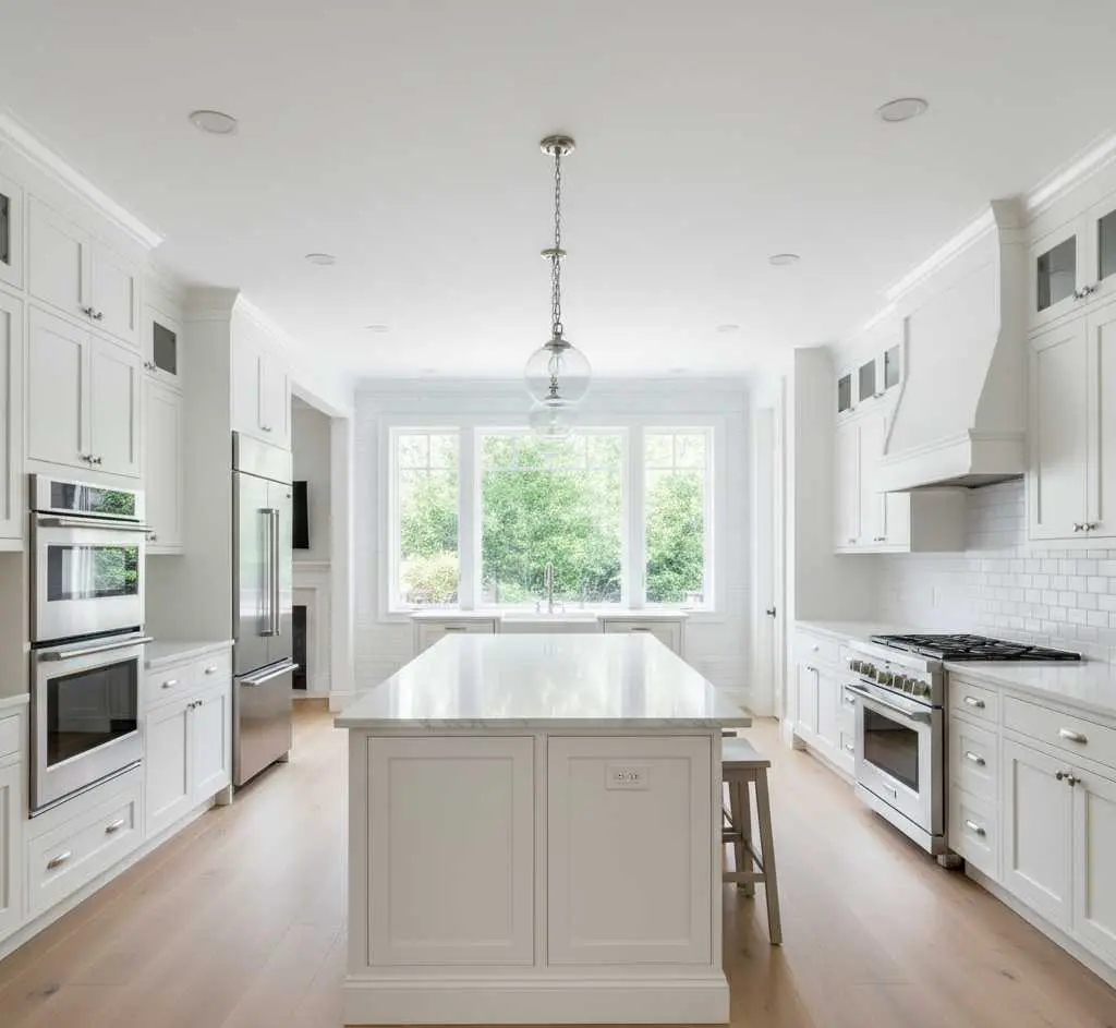 Modern kitchen addition with custom cabinetry and large island in Colorado home for home addition cost estimation