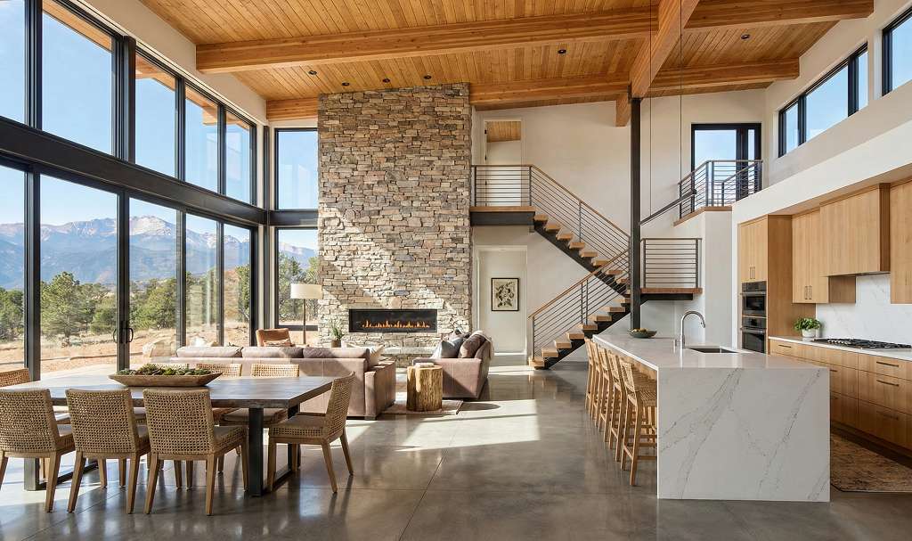 Modern mountain home great room interior with open floor plan and Pikes Peak views through windows